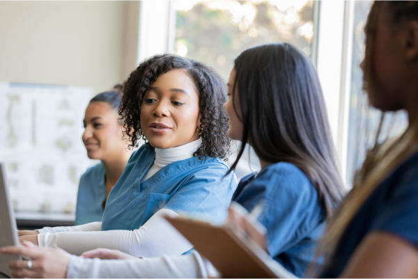 Group of nurses chatting at a table