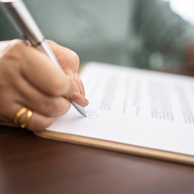 Person writing on legal paper